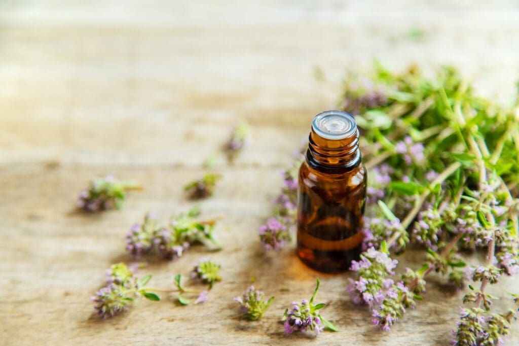 Essential oil of thyme in a bottle. Selective focus.
